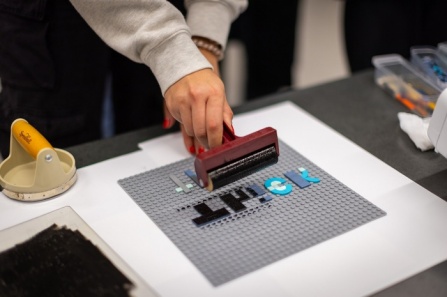Lego pieces serve as a letter press for students in Kelly Myers-Chunco’s Art 321 class. The class was divided into groups and each group used the Lego pieces to develop a new typeface for their final projects. Photos: Douglas Levere. 
