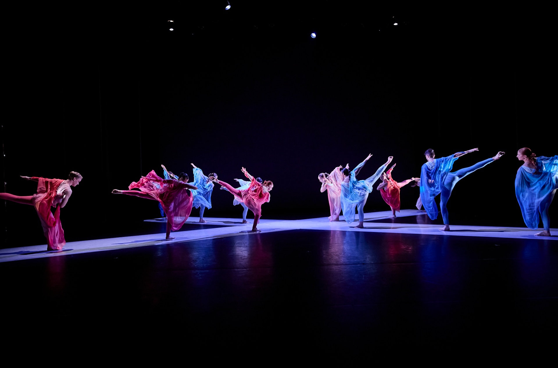 two dancers on stage supported by four musicians in rear.